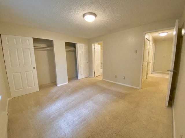 an empty living room with an open door