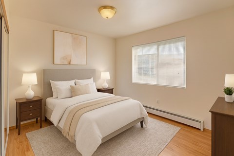 A bedroom with a large bed and a painting on the wall.