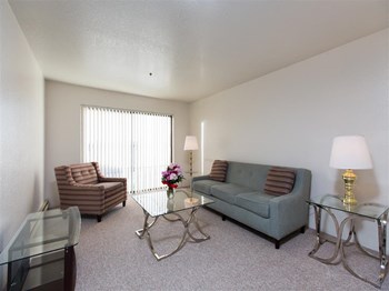 The Outlook Apartment living room with natural lighting and tall windows The Outlook Apartment living room with natural lighting - Photo Gallery 5