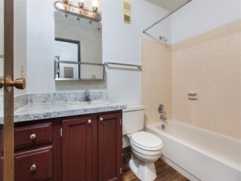 The Outlook Apartment large bathroom with wooden floors and full bathtub - Photo Gallery 9