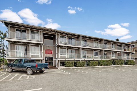 A large building with a parking lot in front of it.
