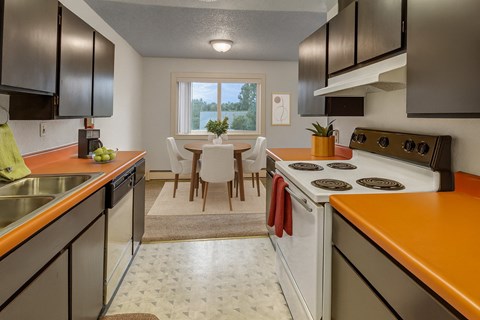 A kitchen with a white stove top oven and orange countertops.