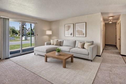 A living room with a white couch and a coffee table.