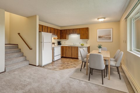 A kitchen with a table and chairs in the middle of the room.