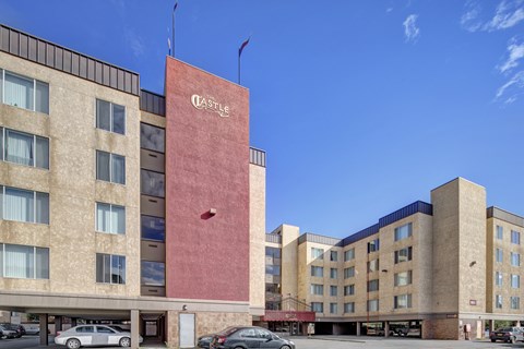 Exterior view with covered parking area at Castle Homes Apartments, Anchorage, AK