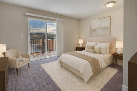 A bedroom with a large bed and a chair by a window.
