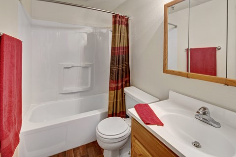 A white toilet sits next to a white sink in a bathroom.