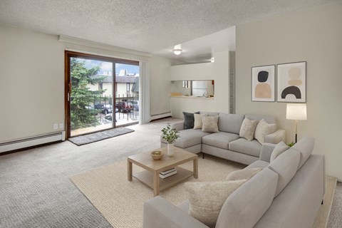 A living room with a grey couch and a coffee table.