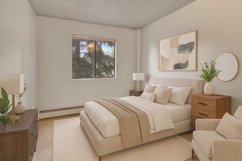A cozy bedroom here at Deer Park featuring a neutral-toned upholstered bed with white bedding and a soft taupe throw, matching wood nightstands with lamps, modern abstract wall art, plush carpeting, and a window providing natural light for a calm, comfortable retreat.