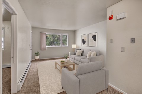 A living room with a grey couch and a small table.