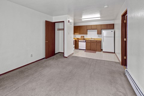 A kitchen area with white appliances and wooden cabinets.