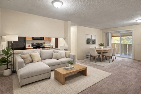 A living room with a grey couch and a wooden coffee table.