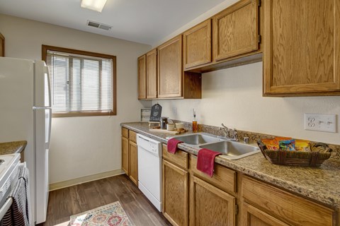 A kitchen with wooden cabinets and a white refrigerator.