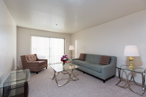 A living room with a couch, chair, and coffee table.