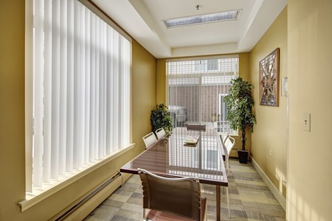 A dining room with a table and chairs.