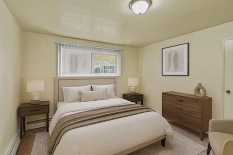 A bedroom with a bed, nightstand, and chair.