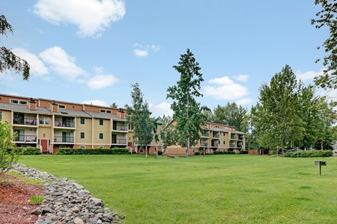 Apartment complex with a green lawn in front.