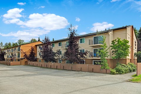 A large building with a parking lot in front of it.
