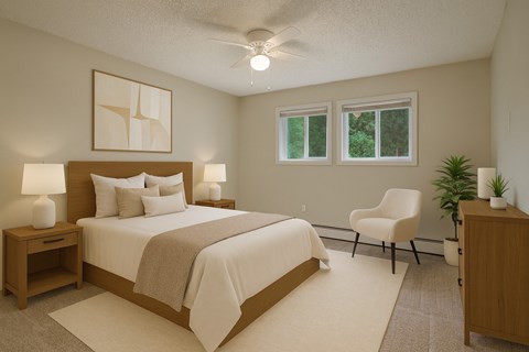 A bedroom with a large bed, a chair, and a plant.