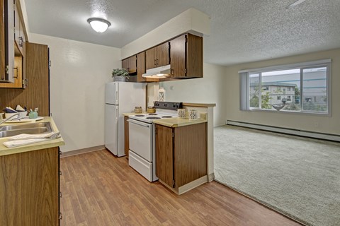 A kitchen with wooden cabinets and a white refrigerator.