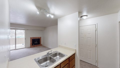 A kitchen with a sink and a fireplace.
