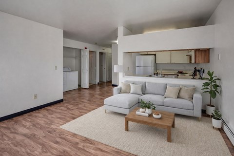 A living room with a white couch and a coffee table.