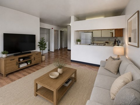 A modern living room with a grey sofa and a wooden coffee table.