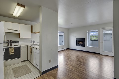 A kitchen with white cabinets and a black oven.