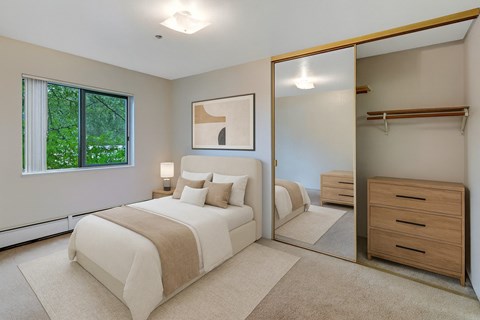 A bedroom with a large bed and a dresser.