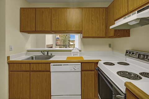 A kitchen with wooden cabinets and white appliances.