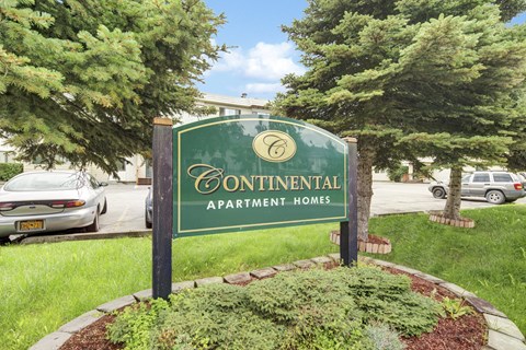 A green sign that says Continental Apartment Homes.