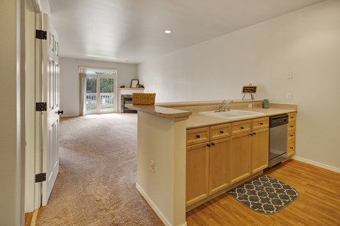 A kitchen with wooden cabinets and a white countertop.