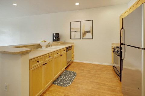 A kitchen with wooden cabinets and a white refrigerator.