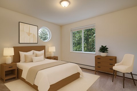 A cozy bedroom here at the Highlands Luxurywith a large, comfortable, and neutral-toned bed. Includes an accent chair in the corner, two nightstands between the bed with soft-toned lamps, a small wooden dresser with a simple plant, and a spacious window overlooking the forest trees. A small circular window sits atop the wall where the bed is placed.