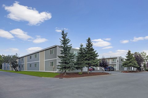 A large building with a parking lot in front of it.