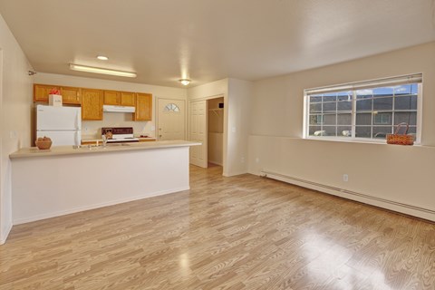 A kitchen with wooden cabinets and a white refrigerator.