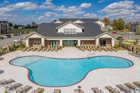 A large house with a pool in front.
