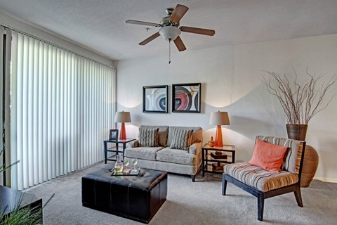 A living room with a striped sofa and a black coffee table.