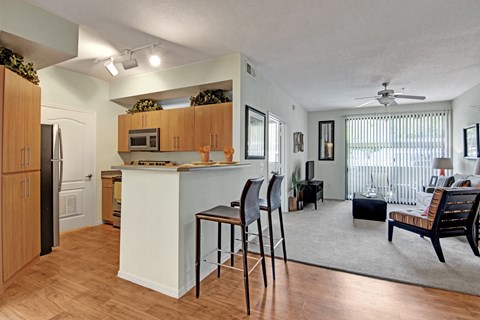 A kitchen with a white island and wooden cabinets.