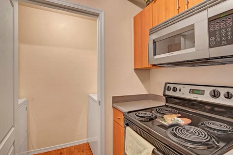 A kitchen with a stove and microwave.