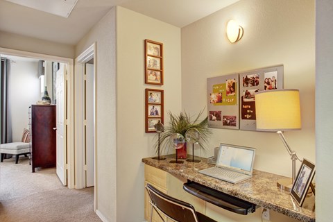A room with a desk and a laptop on it.