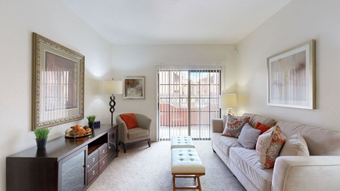 A living room with a couch, a chair, a coffee table, and a painting on the wall.