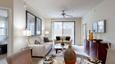A living room with a white couch and a wooden coffee table.