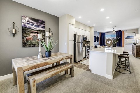 A modern kitchen with a wooden table and bench.