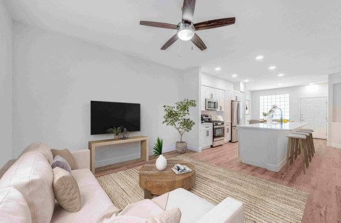 A living room with a white couch and a television.