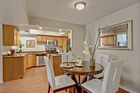 A kitchen with a dining table set for four.