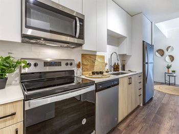 a kitchen with a stove top oven next to a sink