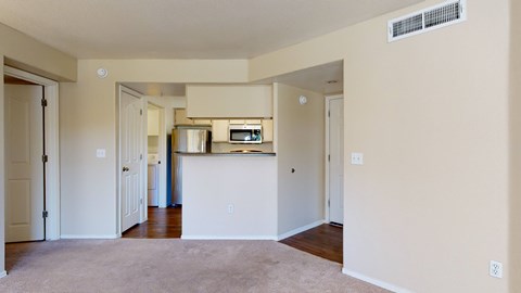 A kitchen area with a microwave and a refrigerator.