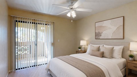 A bedroom with a large bed, a ceiling fan, and a painting on the wall.