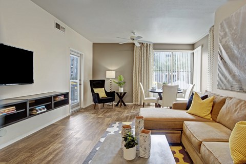A living room with a couch, chair, and television.